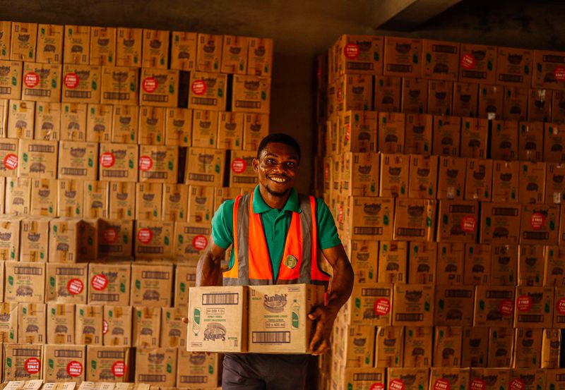Warehouse worker carrying boxes of goods
