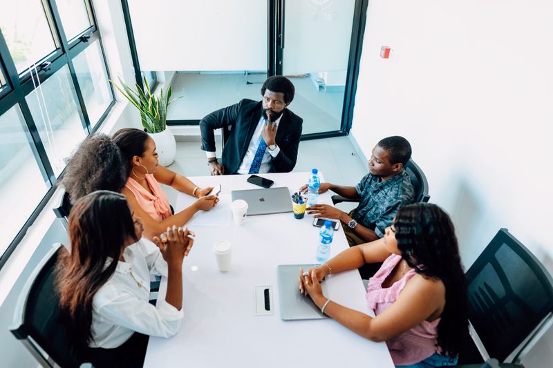 Professionals meeting around a table in a Lagos office